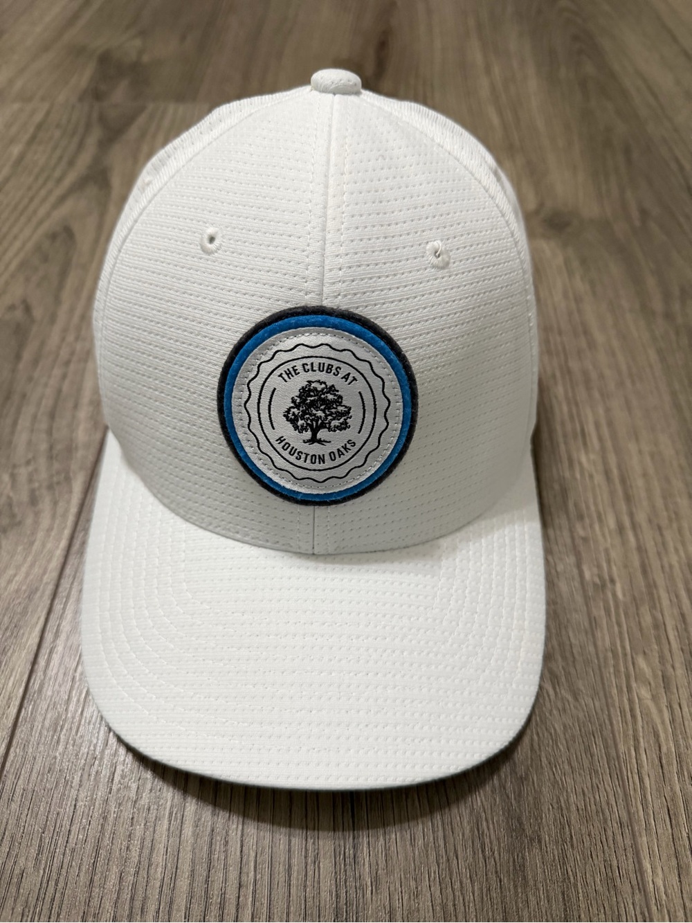 Travis Mathew White Baseball Cap with Blue and Black Logo Patch